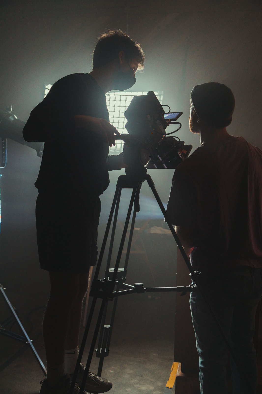 Videographer Bucharest working with camera and studio lighting during video production.